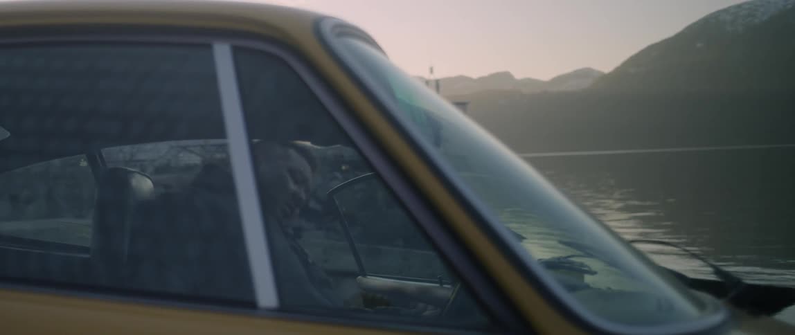 Man Driving Classic Yellow Sports Car