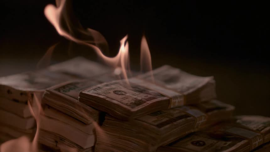 A pile of cash is on fire