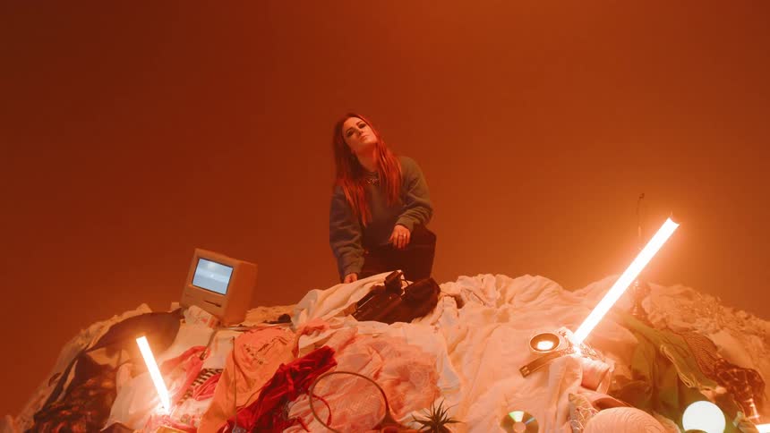Man Playing On Pile Of Clothes In Studio