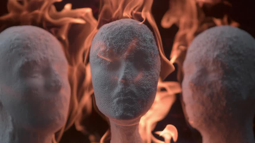 The three mannequin heads melt as they burn
