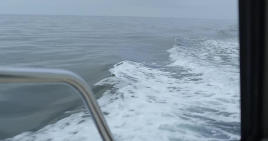 A boat floats on an ocean
