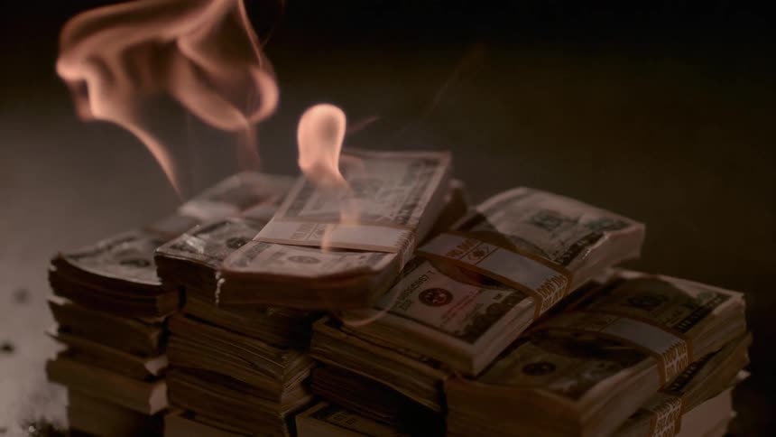 A pile of cash is on fire