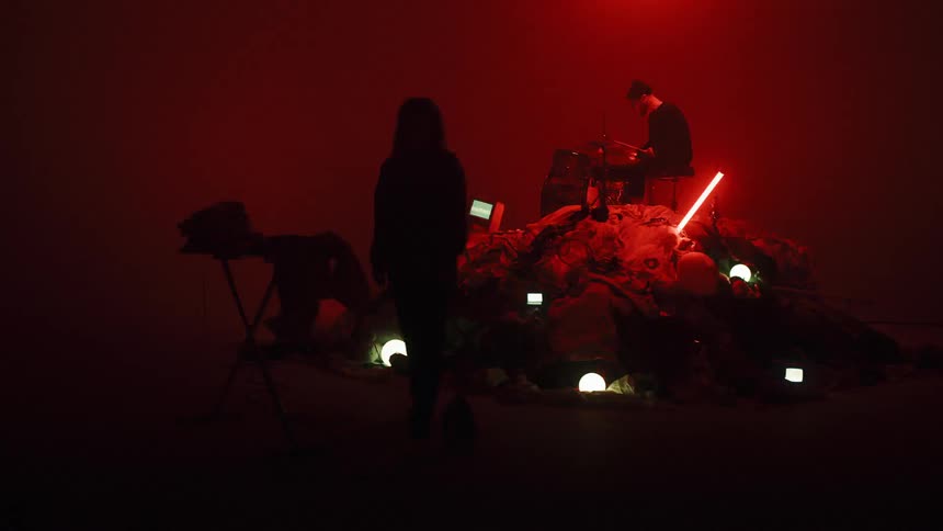 Man Playing On Pile Of Clothes In Studio