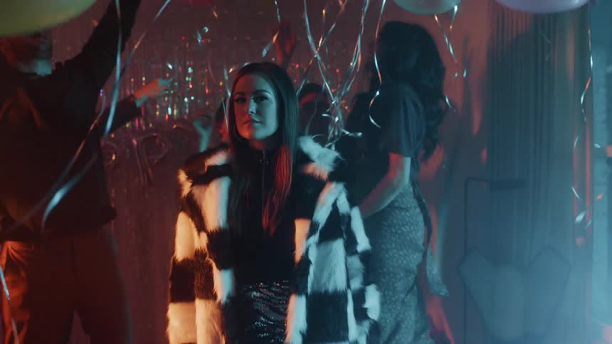 People dance at a party with balloons