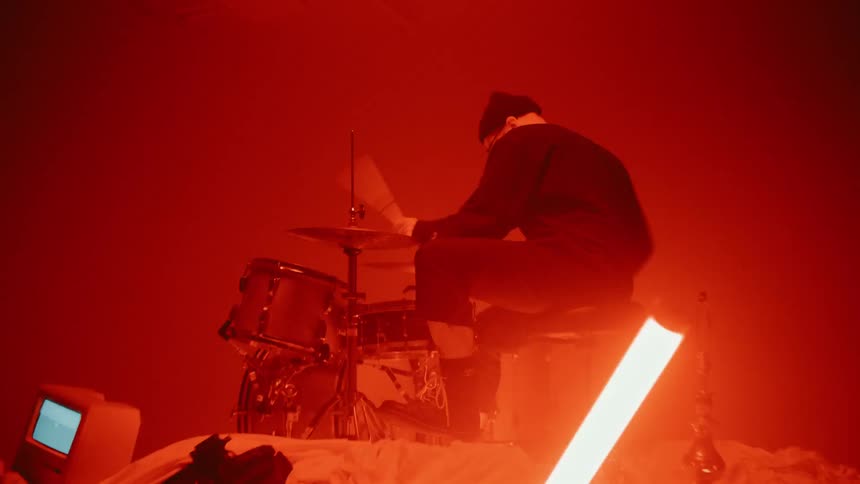 Man Playing On Pile Of Clothes In Studio