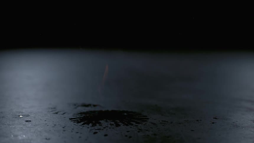 A flaming basketball bounces on the ground