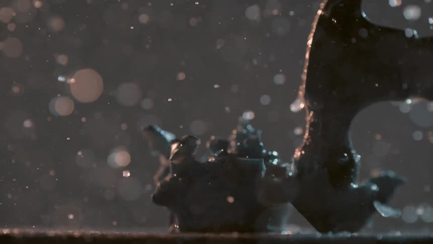 A person smashes a snow globe with a hammer