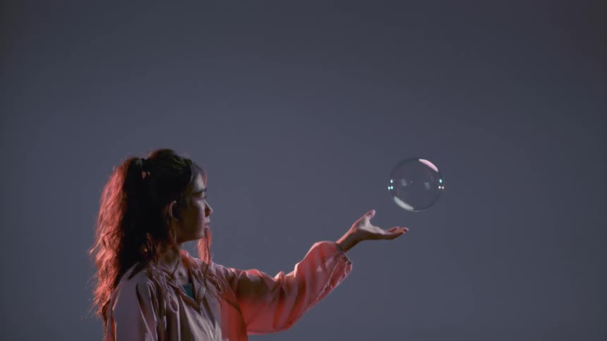 Girl Playing With Bubbles And Balloons In Studio