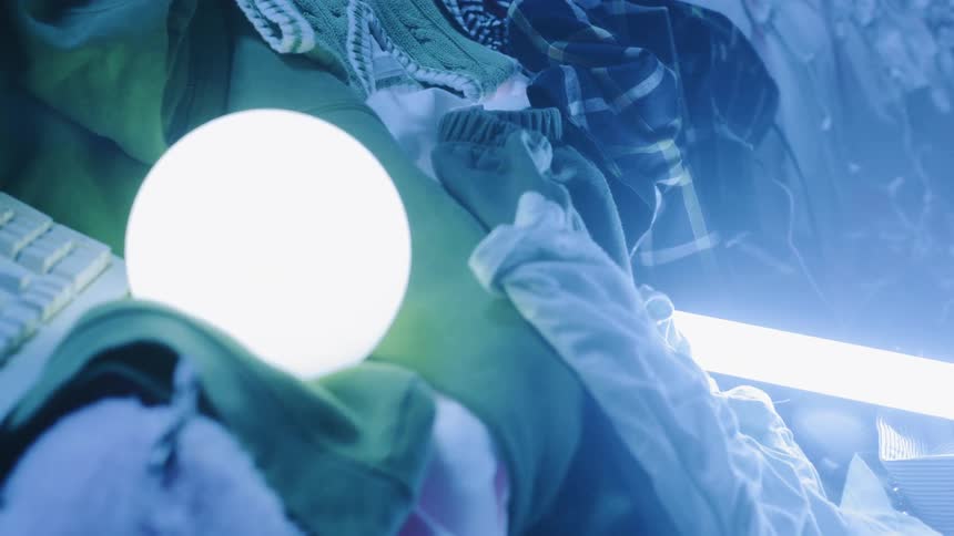 The white glowing orb is laying on the clothes