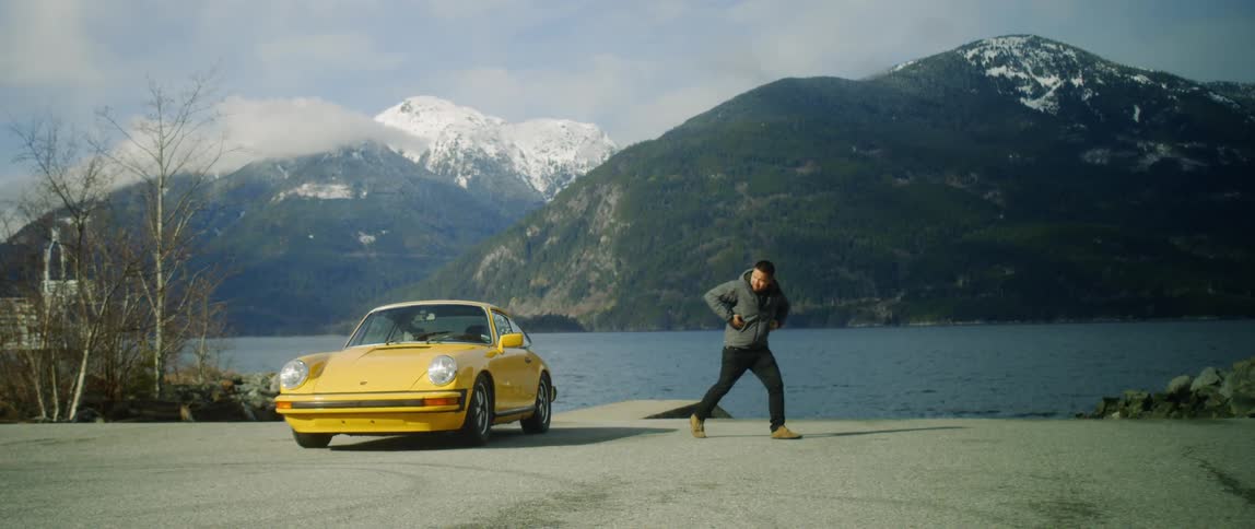 Man Driving Classic Yellow Sports Car