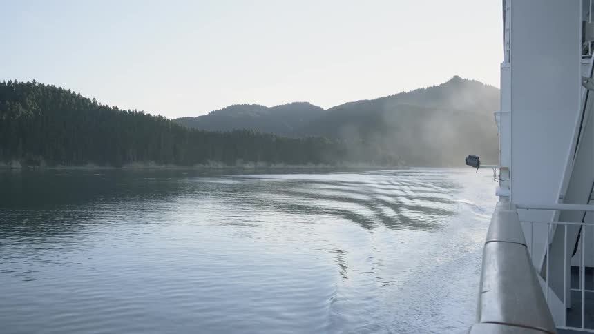 A ship sails on a mountain lake