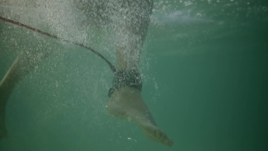 A surfer floats in an ocean