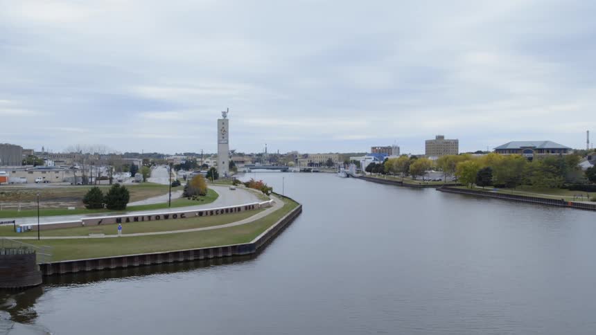 A river flows through a town on a cloudy day