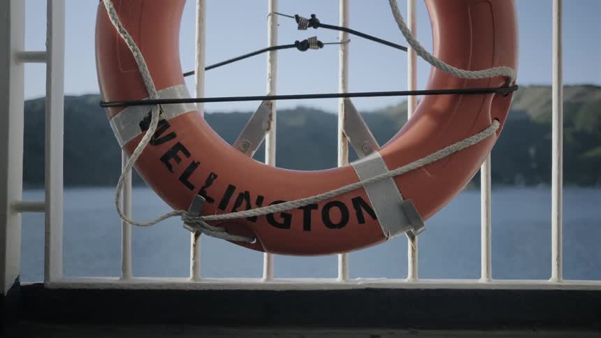 Life preserver hangs on the railing near the water