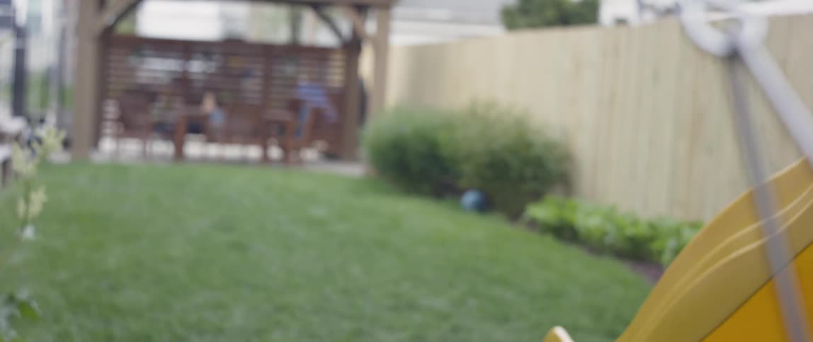 Young girl swings on a swing in a yard