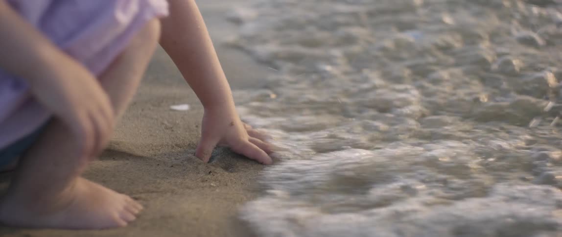 Girl Playing At The Beach