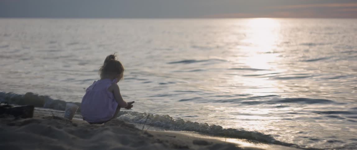 Girl Playing At The Beach