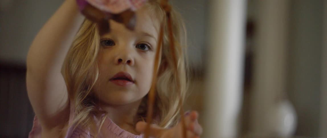 The child is lifting up a string