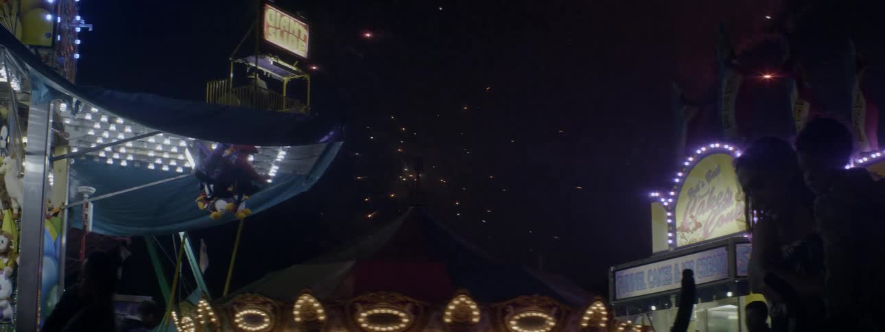 Fireworks explode in the night sky at the carnival