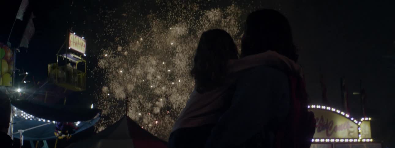The child and parent watch the fireworks