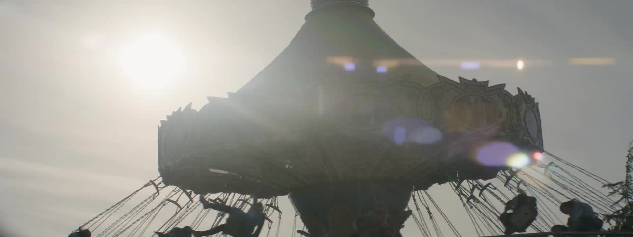 People spin on a carnival ride on a sunny day