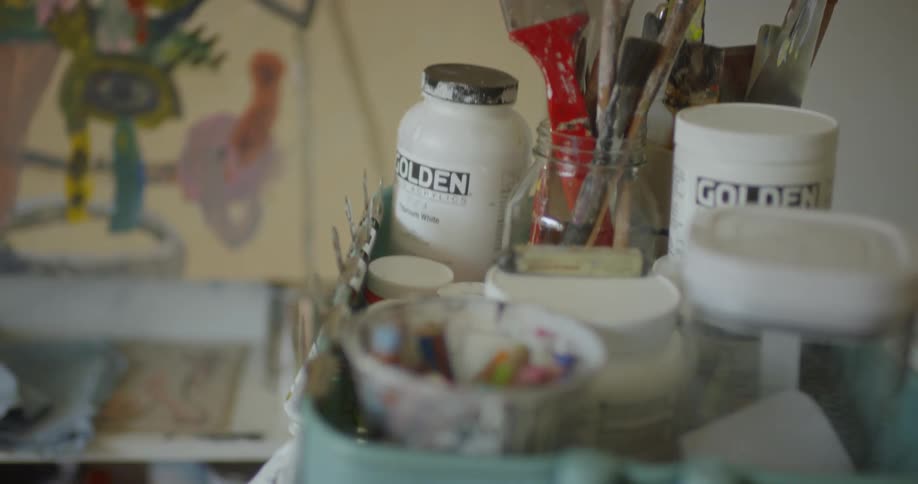 The cart is full of paint and brushes