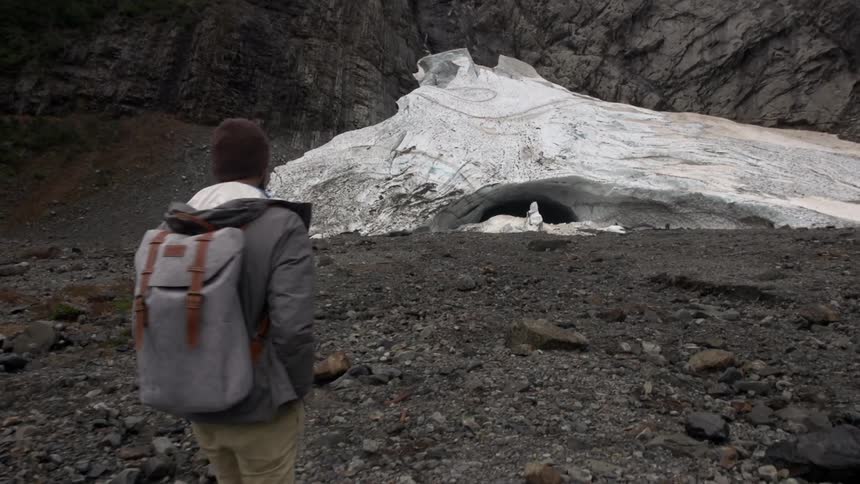 A man is hiking outdoors in the wilderness