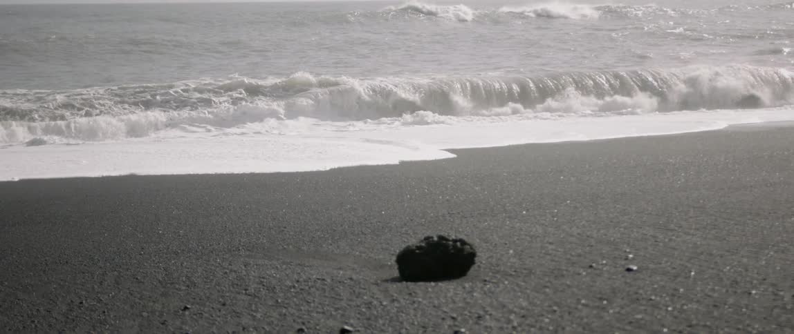 Ocean waves crash onto a sandy beach