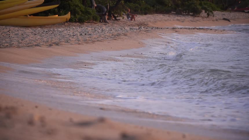 The waves slowly move on the sand of the shore