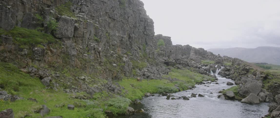 The stream runs by the side of the mountain top