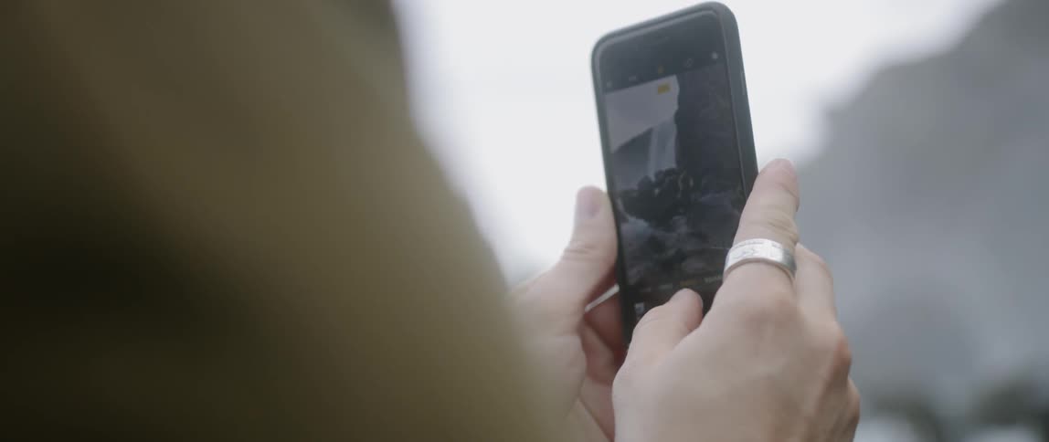A man takes a photo with a smartphone