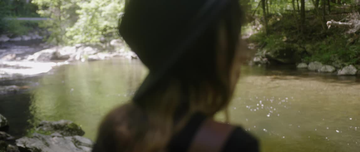 Woman Exploring Woods With Camera