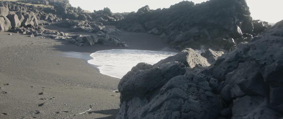 The shore is covered with large rocks