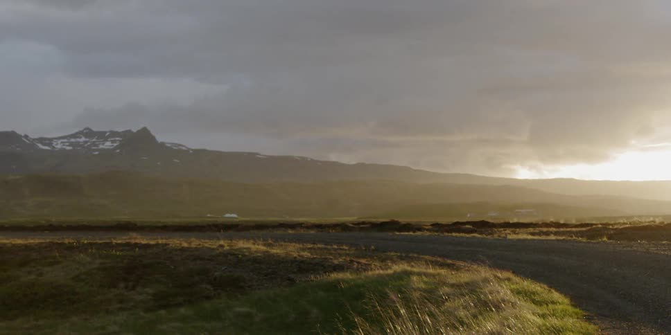 Clouds float over a rural landscape at sunset