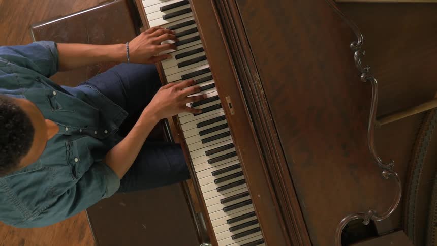 A man plays piano