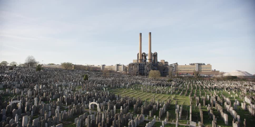 View of a large cemetery with row of buildings in the background