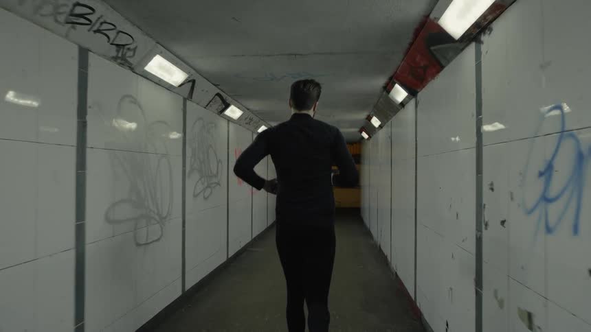 The man is running down the tunnel