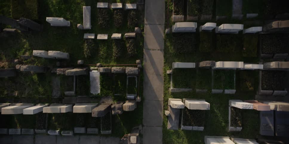 Aerial view of a cemetery with a small concrete path in the middle