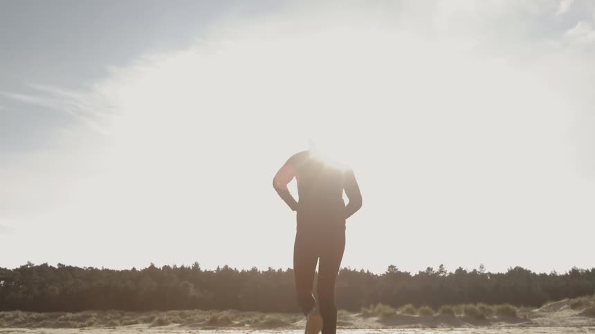 Person jogs on the beach on a sunny day