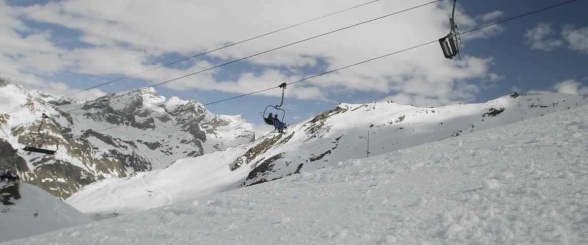 Skiers ride a chairlift at a ski resort