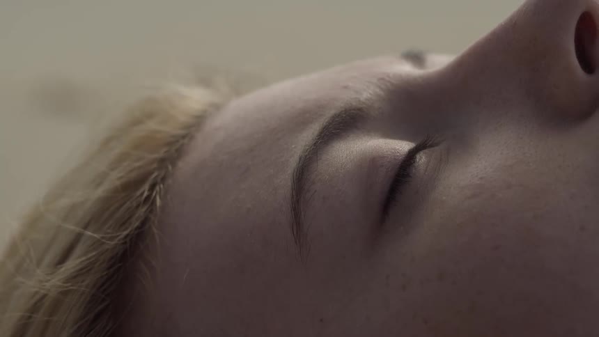 The woman is sleeping on a windy day