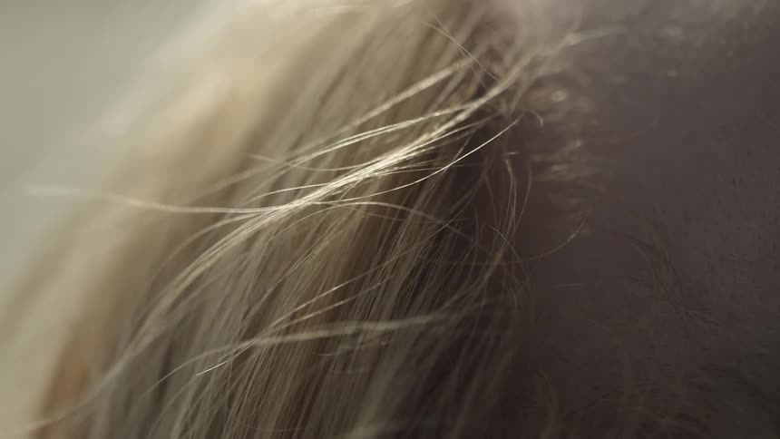 Wind blows through a person's blond hair