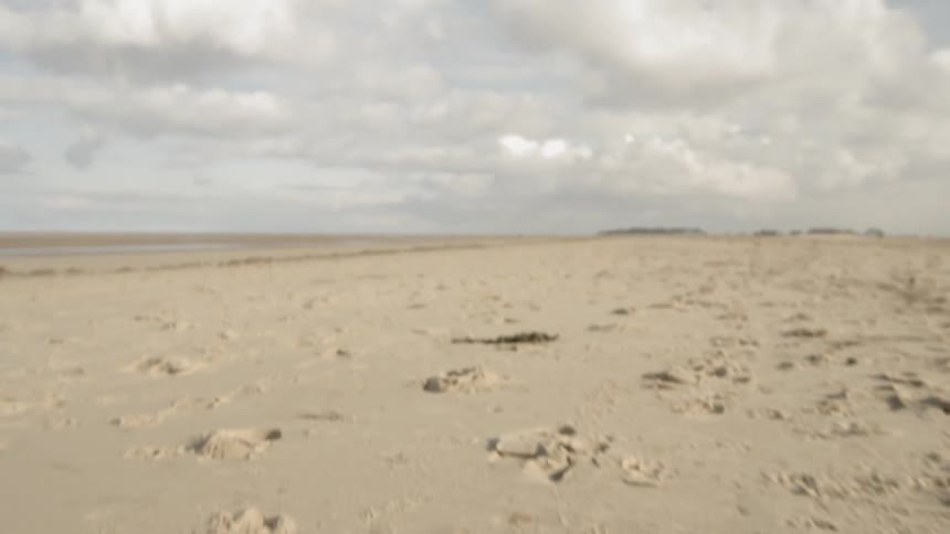The beach is empty on a cloudy day