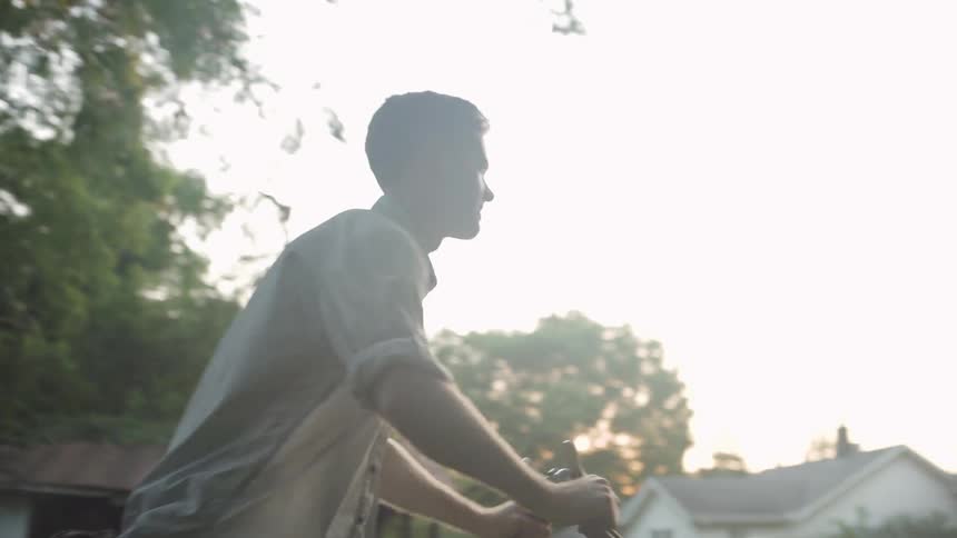 A man mows a backyard