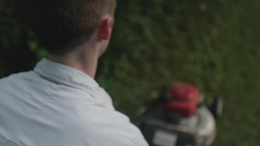 A man mows a lawn