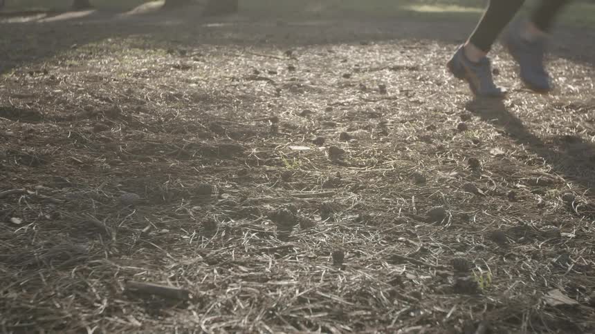 Person running across dried grass
