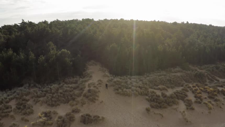 Man Running Through Forest And Dunes