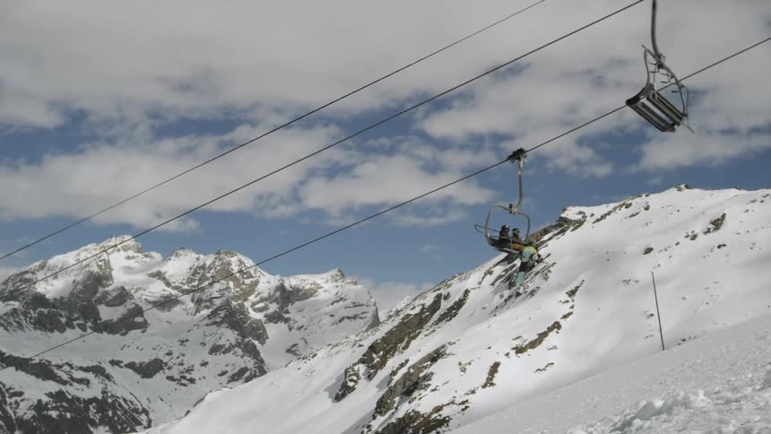 A ski lift carries skiers up the hill