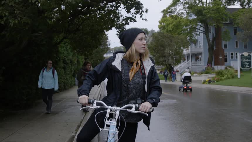 Woman rides a bike on a city street