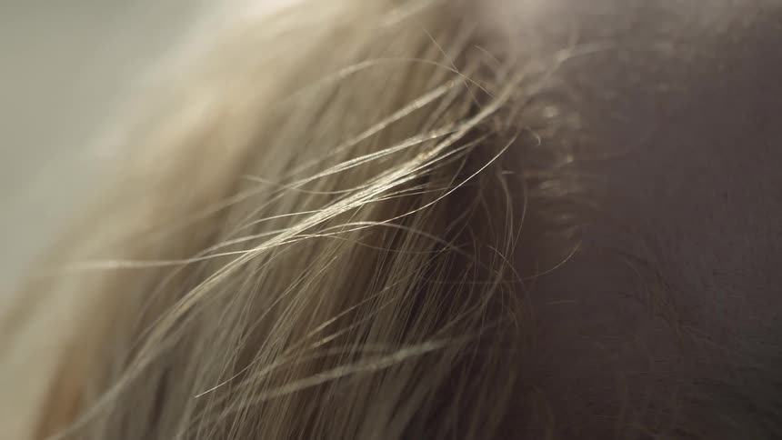 Wind blows through a person's blond hair